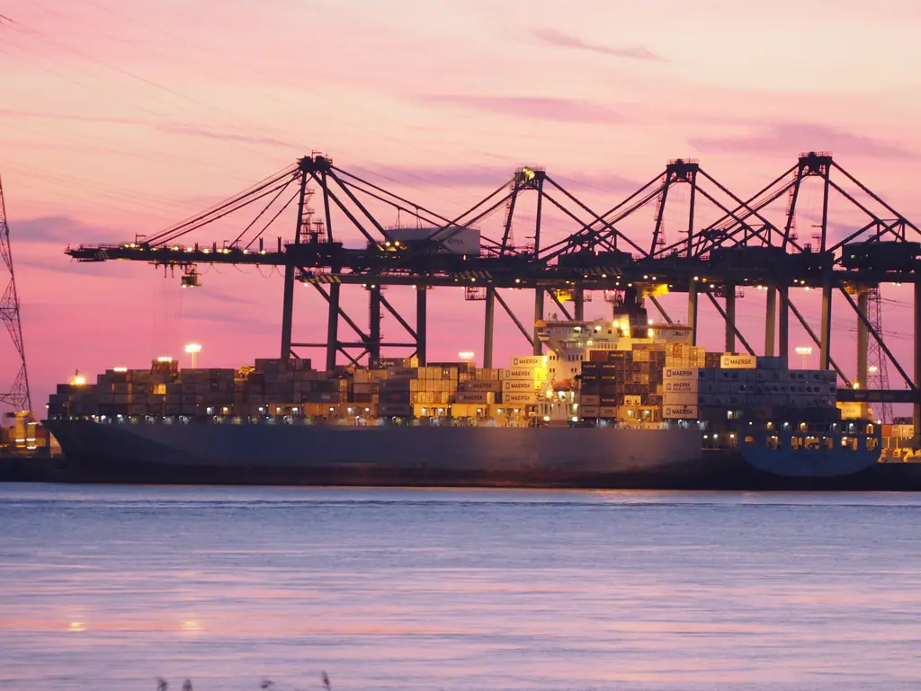 Ship-to-shore cranes at a container terminal at dusk
