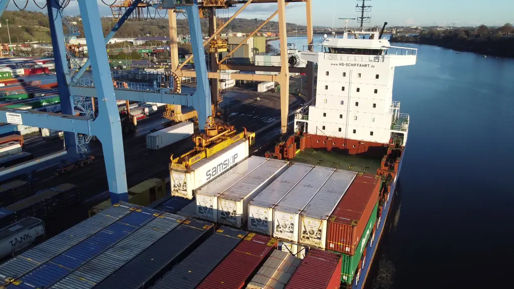 A container being loaded onto a cargo ship at a port terminal